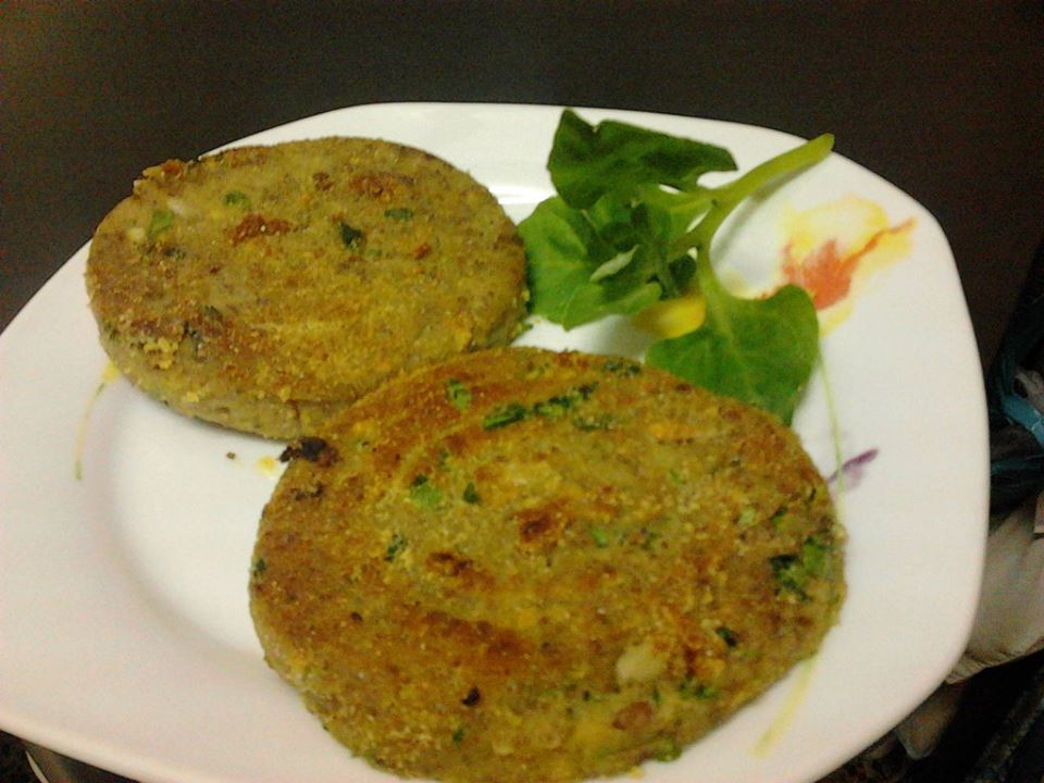 Almond medallions with parsley on a plate.