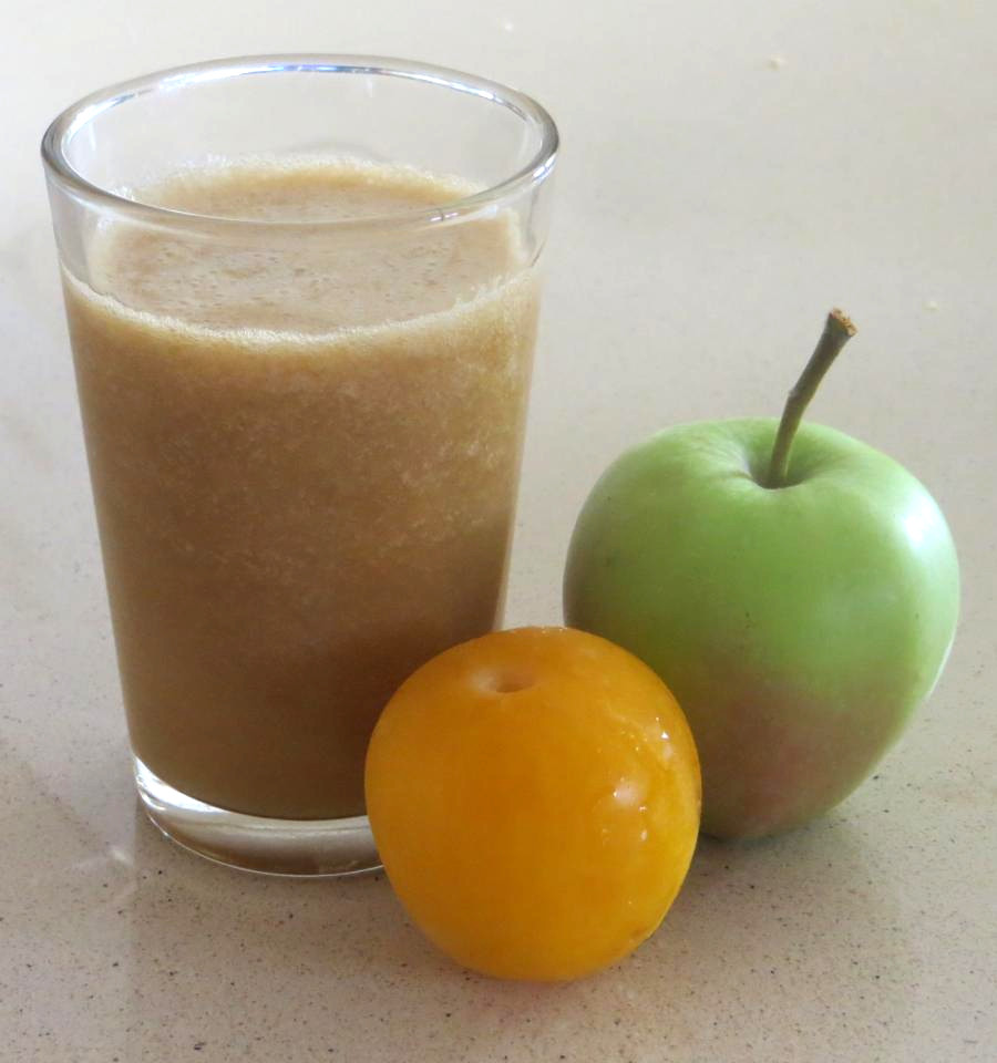 Cup with apple and plum juice, with some cinnamon.