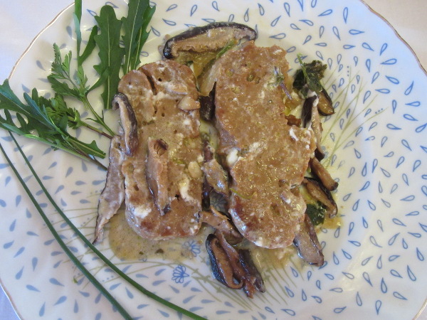 Seitan steaks with shiitake on plate.